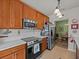 Well-equipped kitchen showcasing stainless steel appliances and a view of the dining area at 1206 Bella Cara Ct, Davenport, FL 33896