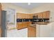 Traditional kitchen featuring wooden cabinets and modern stainless steel appliances at 13711 Dornoch Dr, Orlando, FL 32828