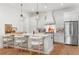 Beautiful kitchen featuring white cabinetry, a spacious island with seating, and modern appliances at 1429 Indiana Ave, Winter Park, FL 32789