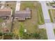 Aerial view of home's backyard with screened patio, mature trees, landscaping, driveway, and storage at 147 13Th Ave, Longwood, FL 32750