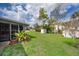 Spacious backyard with green grass, storage sheds, and tropical landscaping offers outdoor enjoyment at 147 13Th Ave, Longwood, FL 32750