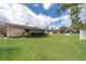 Expansive backyard with lush green lawn, screened-in porch and storage shed at 147 13Th Ave, Longwood, FL 32750