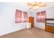 Simple bedroom with ceiling fan, carpeting and two windows for natural light and ventilation at 147 13Th Ave, Longwood, FL 32750