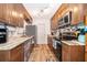 Efficient kitchen has stone counters, wood cabinets, and stainless steel appliances at 147 13Th Ave, Longwood, FL 32750