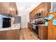 Efficient kitchen has stone counters, wood cabinets, and stainless steel appliances at 147 13Th Ave, Longwood, FL 32750