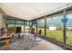 Relaxing sunroom with comfortable seating, string lights, and views of the lush backyard at 147 13Th Ave, Longwood, FL 32750