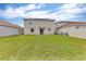 Exterior view of a well-maintained backyard with lush green grass, offering ample space for outdoor activities at 1616 Oak Blossom Dr, Davenport, FL 33837