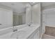 Bathroom with double vanity, a large mirror, and glass shower at 1616 Oak Blossom Dr, Davenport, FL 33837