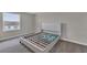 Well-lit bedroom featuring gray carpet, window, and a bed frame at 1616 Oak Blossom Dr, Davenport, FL 33837