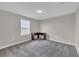 Bedroom featuring neutral walls, soft gray carpet, and a wood-finished corner desk by the window at 1616 Oak Blossom Dr, Davenport, FL 33837