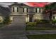 Charming two-story home with neutral stucco, dark shutters, brick driveway and well maintained landscaping at 1616 Oak Blossom Dr, Davenport, FL 33837