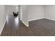 Hallway connecting living spaces with hardwood flooring and neutral walls at 1616 Oak Blossom Dr, Davenport, FL 33837