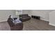 Living room with hardwood flooring, neutral walls, dark couches, and recessed lighting at 1616 Oak Blossom Dr, Davenport, FL 33837