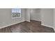 Bright living room featuring wood-look tile flooring and a large window for natural light at 1616 Oak Blossom Dr, Davenport, FL 33837