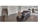 Open-concept living room and kitchen with hardwood flooring, modern furniture, and stairs at 1616 Oak Blossom Dr, Davenport, FL 33837