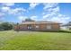 The backyard has plenty of grass and is partially fenced at 1644 Piccadilly Dr, Daytona Beach, FL 32117