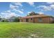 The backyard provides ample space, enhanced by lush green grass and exterior home view at 1644 Piccadilly Dr, Daytona Beach, FL 32117