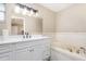 Bathroom vanity with a large mirror and a relaxing soaking tub at 1644 Piccadilly Dr, Daytona Beach, FL 32117