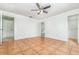 Open bedroom featuring a ceiling fan, closet, and bathroom with tile flooring at 1644 Piccadilly Dr, Daytona Beach, FL 32117