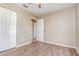 Bright bedroom features wood-look floors, ceiling fan, and double door closet at 1644 Piccadilly Dr, Daytona Beach, FL 32117