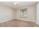 Bedroom features a ceiling fan, wood-look flooring, and natural light at 1644 Piccadilly Dr, Daytona Beach, FL 32117