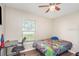 Bright bedroom features a ceiling fan and a window with natural light at 1644 Piccadilly Dr, Daytona Beach, FL 32117