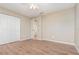Bedroom features a ceiling fan, wood-look flooring, and closet space at 1644 Piccadilly Dr, Daytona Beach, FL 32117