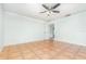 Empty bedroom featuring a ceiling fan, and bathroom with tile flooring at 1644 Piccadilly Dr, Daytona Beach, FL 32117