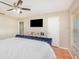 Large main bedroom with a ceiling fan, tv, and view of the side window at 1644 Piccadilly Dr, Daytona Beach, FL 32117