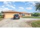 Well-maintained single-story home featuring a two-car garage and a paved driveway at 1644 Piccadilly Dr, Daytona Beach, FL 32117