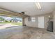 Open garage space shows concrete flooring, water heater, electrical panel, and side door at 1644 Piccadilly Dr, Daytona Beach, FL 32117