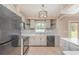 Charming kitchen featuring stainless steel appliances, tile backsplash, and modern lighting at 1644 Piccadilly Dr, Daytona Beach, FL 32117