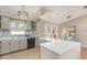 Stylish kitchen with grey cabinets, stainless appliances, island, and a large window above the sink at 1644 Piccadilly Dr, Daytona Beach, FL 32117