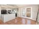 Bright kitchen features stainless appliances, island with breakfast bar, and view of sliding glass doors at 1644 Piccadilly Dr, Daytona Beach, FL 32117