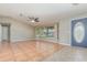 Bright living room featuring tile floors, a bay window, and a decorative front door at 1644 Piccadilly Dr, Daytona Beach, FL 32117