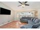 Comfortable living room with a large sectional sofa, tile floors, and a ceiling fan at 1644 Piccadilly Dr, Daytona Beach, FL 32117