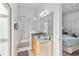 Bright bathroom with a glass-enclosed shower, a vanity with ample counter space, and a large mirror at 16613 Caribbean Breeze Way # 34714, Clermont, FL 34714