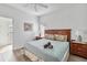 Comfortable bedroom featuring a queen-size bed with a wooden headboard, bedside tables, and ample natural light at 16613 Caribbean Breeze Way # 34714, Clermont, FL 34714