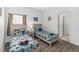 Bright bedroom featuring twin beds with playful Batman-themed bedding and a neutral color scheme at 16613 Caribbean Breeze Way # 34714, Clermont, FL 34714