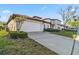 Charming two-story home featuring a red tile roof, white stucco, and manicured landscaping at 16613 Caribbean Breeze Way # 34714, Clermont, FL 34714