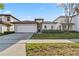 Charming single-story home with a well-maintained lawn and a red tile roof at 16613 Caribbean Breeze Way # 34714, Clermont, FL 34714