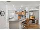 Open kitchen features bar seating and modern appliances at 16613 Caribbean Breeze Way # 34714, Clermont, FL 34714
