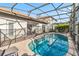 Secluded screened-in pool features ample seating and sunny skies for outdoor enjoyment and relaxing at 16613 Caribbean Breeze Way # 34714, Clermont, FL 34714