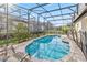 This private screened pool features a custom brick surround, mature landscaping, and plenty of lounge seating at 16613 Caribbean Breeze Way # 34714, Clermont, FL 34714