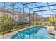 Private screened-in pool offers a refreshing oasis, surrounded by brick pavers and landscaping at 16613 Caribbean Breeze Way # 34714, Clermont, FL 34714