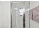 Modern glass-enclosed shower with white tile at 16613 Caribbean Breeze Way # 34714, Clermont, FL 34714