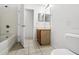 Bright bathroom features tile floors, a tub/shower combo, and a vanity at 16817 Gold Star Ct, Clermont, FL 34714