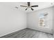 Bright bedroom features wood floors, a ceiling fan, and a large window for ample natural light at 16817 Gold Star Ct, Clermont, FL 34714