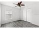 Bright bedroom with wood floors features a ceiling fan, a window, and closet space at 16817 Gold Star Ct, Clermont, FL 34714
