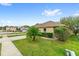 A charming single-Gathering home with lush landscaping, a well-manicured lawn, and proximity to neighboring houses at 16817 Gold Star Ct, Clermont, FL 34714